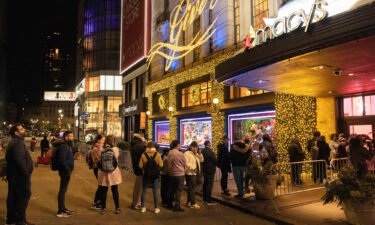 People wait in line to enter Macy's department store during Black Friday in New York City on November 25.