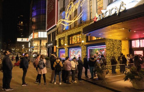 People wait in line to enter Macy's department store during Black Friday in New York City on November 25.