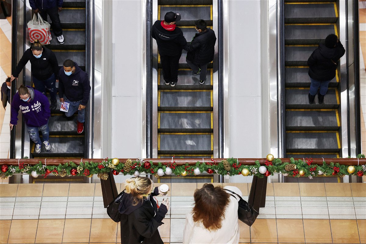 <i>Andrew Kelly/Reuters</i><br/>People ride an escalator while others stand at a mall during the holiday season shopping in Brooklyn