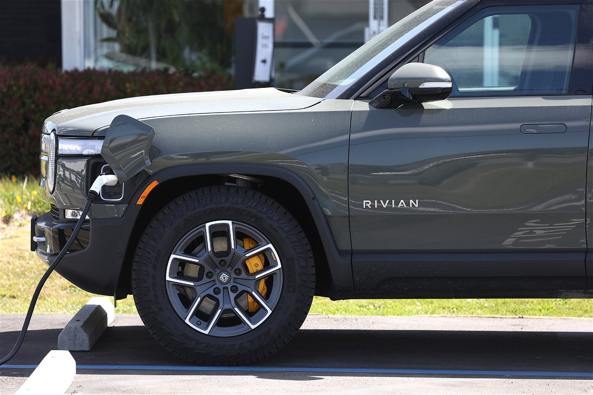 <i>Justin Sullivan/Getty Images</i><br/>A Rivian electric pickup truck sits in a parking lot at a Rivian service center on May 9 in South San Francisco