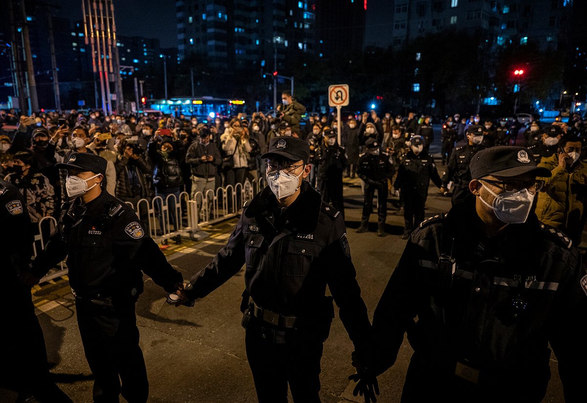 <i>Kevin Frayer/Getty Images</i><br/>Police form a cordon  during a protest in Beijing on November 27.
