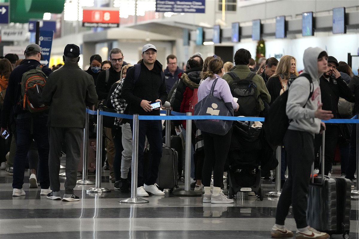 <i>Nam Y. Huh/AP</i><br/>Sunday marked the busiest day at US airports since the start of the pandemic. Travelers wait to go through security check point at O'Hare International Airport in Chicago