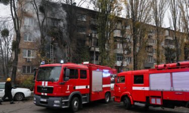 Firefighters work to put out a fire after a Russian strike hit a residential building in Kyiv on Tuesday.