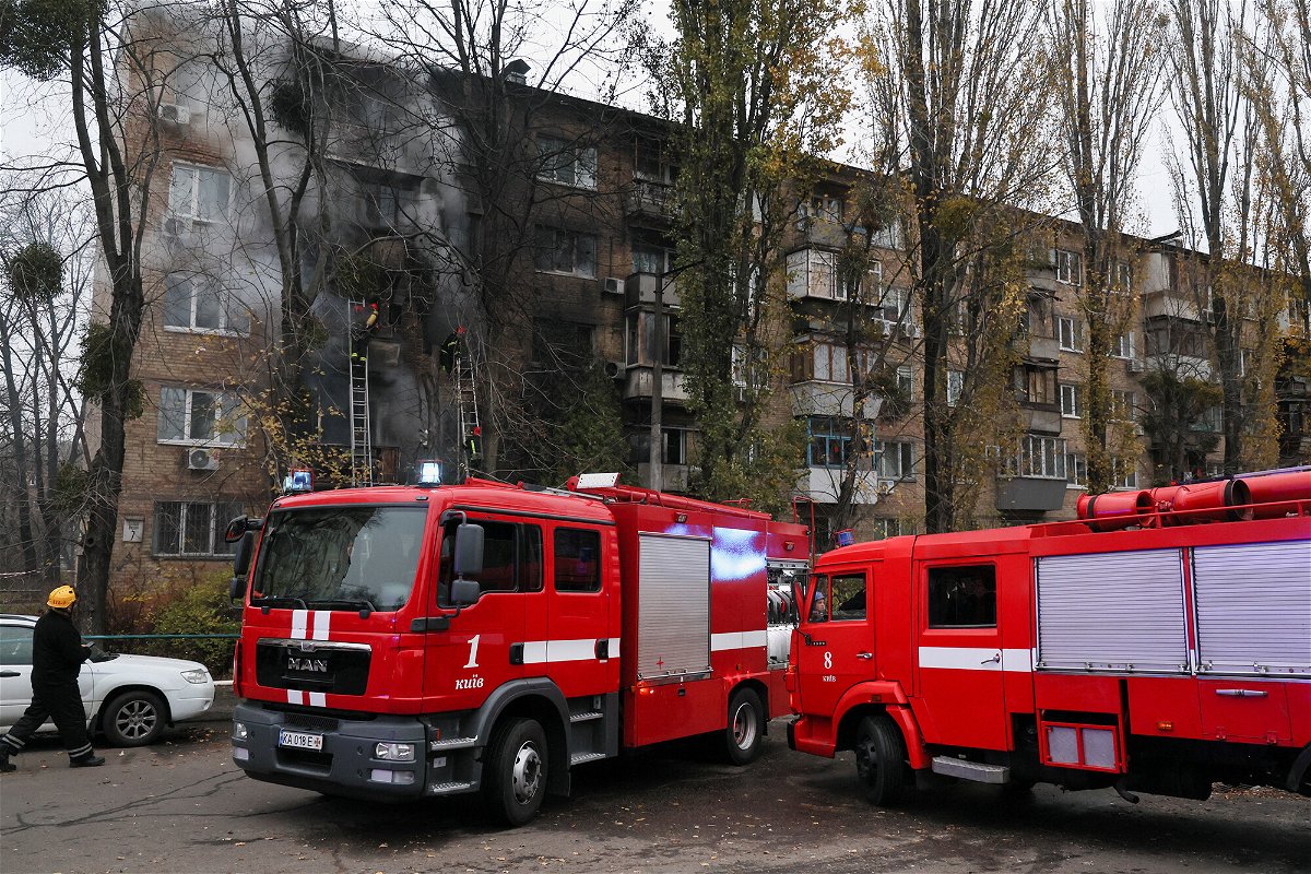 <i>Gleb Garanich/Reuters</i><br/>Firefighters work to put out a fire after a Russian strike hit a residential building in Kyiv on Tuesday.