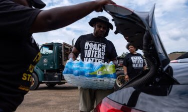 Residents distribute cases of water last September in Jackson