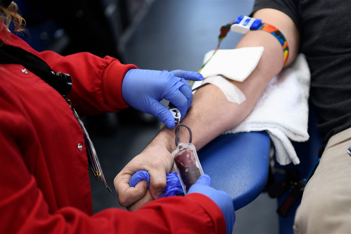 <i>Patrick T. Fallon/AFP/Getty Images/FILE</i><br/>A person donates blood during a Children's Hospital Los Angeles blood donation drive on January 13. The US Food and Drug Administration is considering shifting its blood donation policy away from blanket assessments toward questionnaires that focus more on individual risk.