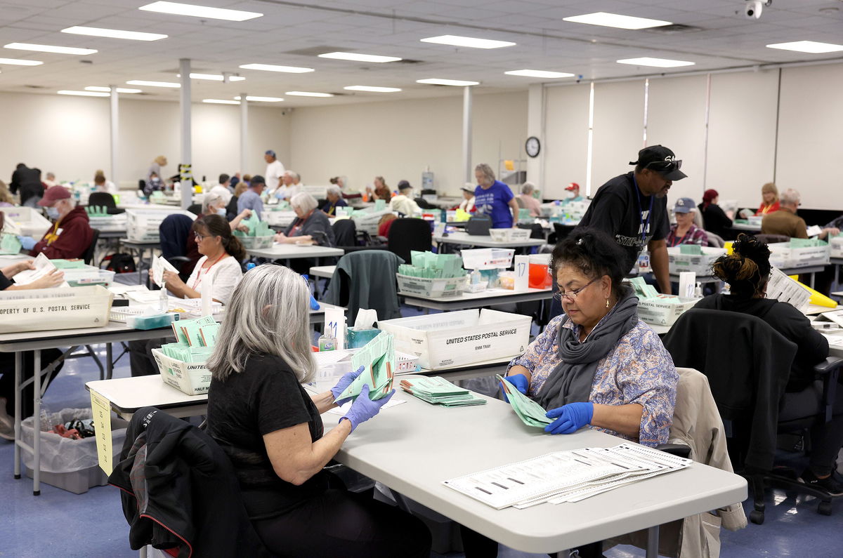<i>Justin Sullivan/Getty Images</i><br/>Election workers open mail in ballots at the Maricopa County Tabulation and Election Center on November 11