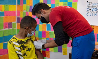 Covid-19 boosters could keep thousands of kids out of hospitals. 10-year-old Ernest "EJ" Jones gets his Covid-19 booster vaccine at a Pharmacy in Schwenksville