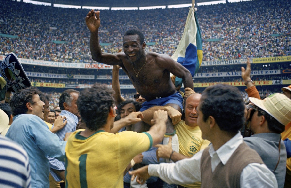 FILE - Brazil's Pele is hoisted on the shoulders of his teammates after Brazil won the World Cup final against Italy, 4-1, in Mexico City's Estadio Azteca, June 21, 1970.  Pelé, the Brazilian king of soccer who won a record three World Cups and became one of the most commanding sports figures of the last century, died in sao Paulo on Thursday, Dec. 29, 2022. He was 82. 