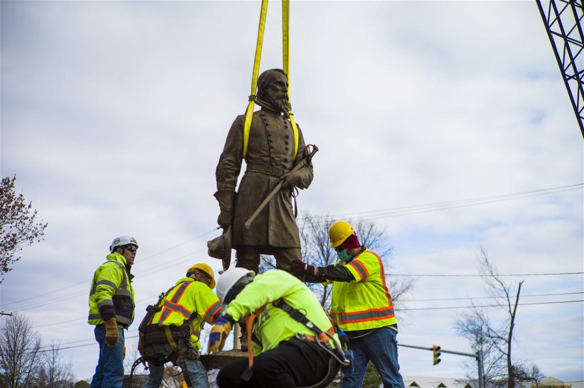 Workers prep the statue of Confederate General A.P. Hill to be laid on flatbed truck on Monday Dec. 12, 2022  in Richmond, Va.