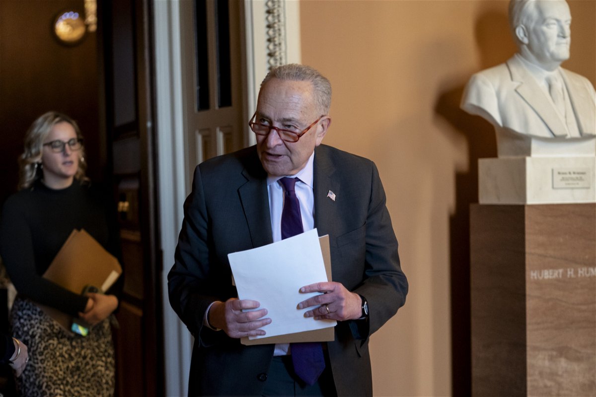 Senate Majority Leader Chuck Schumer, D-N.Y., emerges from a closed-door meeting with fellow Democrats before speaking with reporters, at the Capitol in Washington, Tuesday, Dec. 13, 2022. 