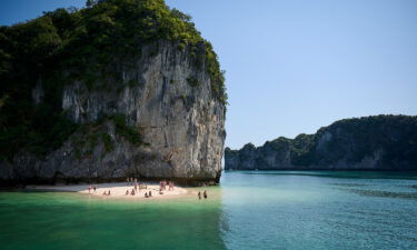 Tourists rest on the beach