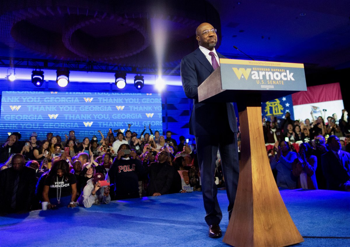 <i>Carlos Barria/Reuters</i><br/>Sen. Raphael Warnock speaks during an Election Night party after a projected win in the US midterm runoff election against his Republican challenger Herschel Walker in Atlanta