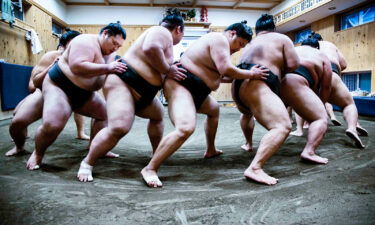 Wrestlers partake in a practice drill at their "beya