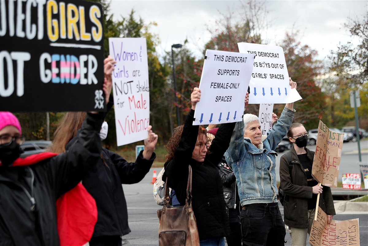 <i>Leah Millis/Reuters</i><br/>People gather to protest different issues including the board's handling of a sexual assault that happened in a school bathroom in May 2021.