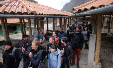 Stranded tourists walk through Chilca