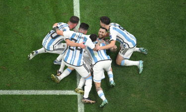 Lionel Messi celebrates with teammates after scoring Argentina's first goal of the World Cup final.