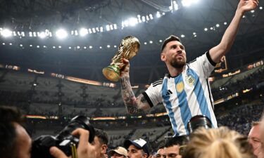 Argentina's captain and forward Lionel Messi holds the FIFA World Cup Trophy following the ceremony after Argentina won the Qatar 2022 World Cup final on December 18.