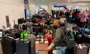 Baggage waits to be claimed after canceled flights at the Southwest Airlines terminal at Los Angeles International Airport on Monday