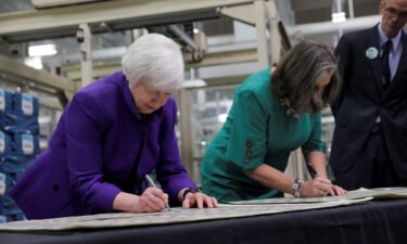 Treasury Secretary Janet Yellen and Treasury Chief Lynn Malerba sign on banknotes during  the unveiling of the first U.S. banknotes printed with two women's signatures at an event in Fort Worth