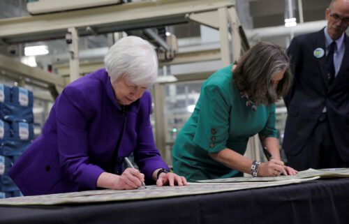 Treasury Secretary Janet Yellen and Treasury Chief Lynn Malerba sign on banknotes during  the unveiling of the first U.S. banknotes printed with two women's signatures at an event in Fort Worth