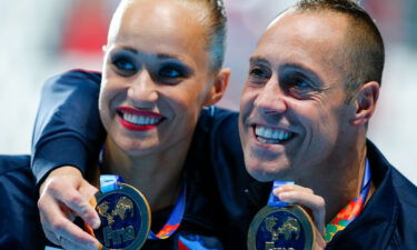 Christina Jones and Bill May of the US pose with their gold medals after the synchronised swimming mixed duet technical final at the Aquatics World Championships in Kazan