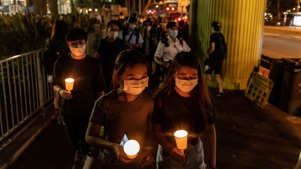 <i>Anthony Kwan/Getty Images</i><br/>People hold candles as they walk near the Victoria Park on June 4