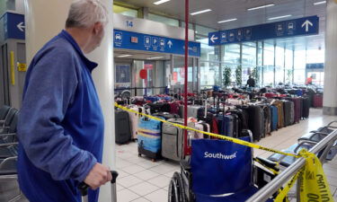 A traveler looks at luggage in the baggage claim area inside the Southwest Airlines terminal at St. Louis Lambert International Airport on Wednesday.