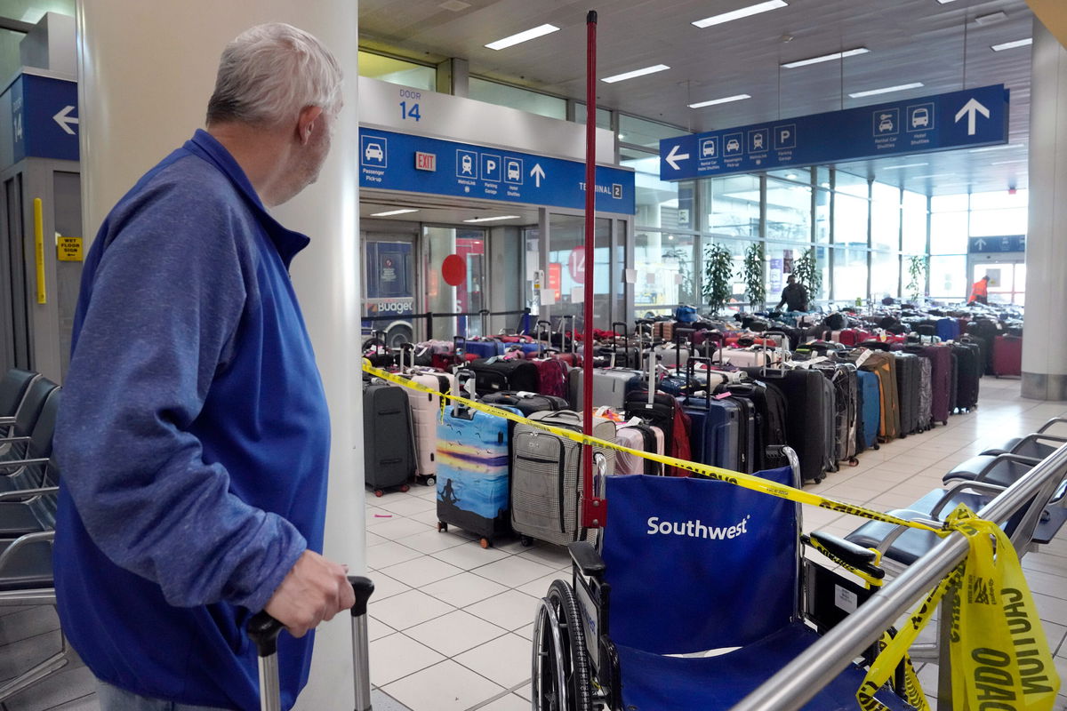 <i>Jeff Roberson/AP</i><br/>A traveler looks at luggage in the baggage claim area inside the Southwest Airlines terminal at St. Louis Lambert International Airport on Wednesday.