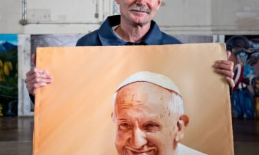 One of phogographer Peter Merts' subjects with an acrylic painting of Pope Francis in 2016. The man was released from prison three years later and now owns a property where he builds micro-homes for homeless people and those who have been released from prison.