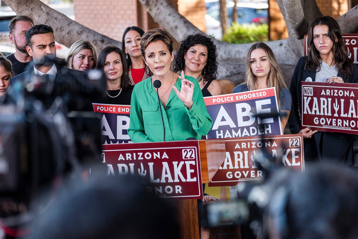 <i>Olivier Touron/AFP/Getty Images</i><br/>Kari Lake holds a press conference in front of her campaign headquarters in Phoenix