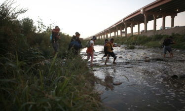 The Biden administration is considering a proposal that would bar migrants from seeking asylum at the US-Mexico border if they could have received refuge in another country. Venezuelan migrants are pictured walking across the Rio Bravo on October 13.