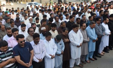 Mourners offer absentia funeral prayers in Karachi on October 27 for Sharif.