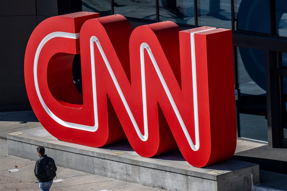 <i>Brandon Bell/Getty Images/FILE</i><br/>A person walks past the CNN headquarters on November 17 in Atlanta