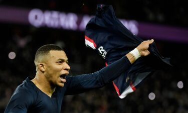 Kylian Mbappé celebrates after scoring a last-minute penalty for PSG in his first match since the World Cup final.
