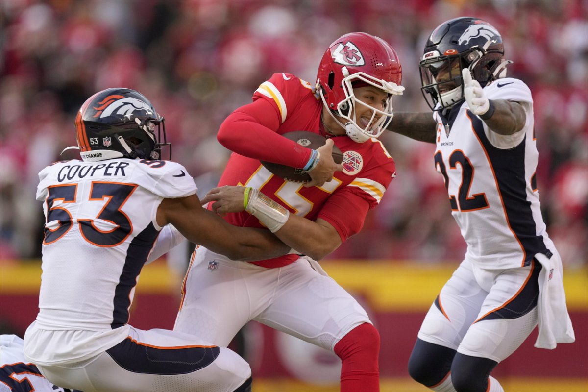 Kansas City Chiefs quarterback Patrick Mahomes (15) is stopped by Denver Broncos linebacker Jonathon Cooper and safety Kareem Jackson (22) during the second half of an NFL football game Sunday, Jan. 1, 2023, in Kansas City, Mo. 