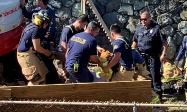One person is dead and two others are injured after being crushed by a falling rock wall outside of a home in Kailua.