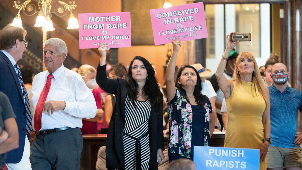 <i>Sean Rayford/SOPA Images/LightRocket via Getty Images</i><br/>Protesters hold signs inside the South Carolina Statehouse as lawmakers debate an abortion ban in August