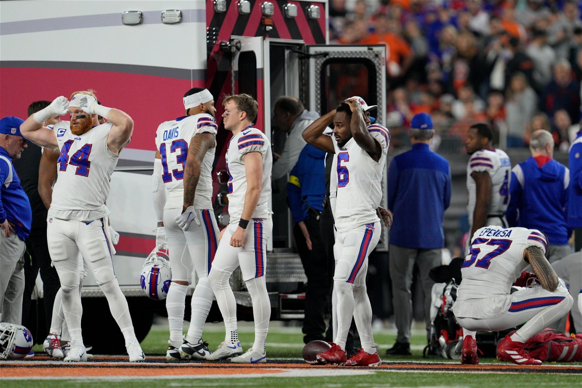<i>Jeff Dean/AP</i><br/>Buffalo Bills players react as teammate Damar Hamlin is examined during the first half of an NFL football game against the Cincinnati Bengals