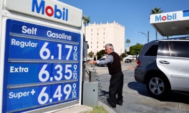 The Mobil logo and gas prices are displayed at a Mobil gas station on October 28