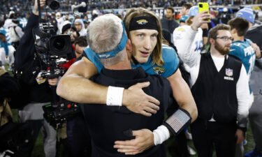 Trevor Lawrence celebrates on the field after the Jaguars defeated the Los Angeles Chargers 31-30 in the AFC Wild Card playoff game at TIAA Bank Field on January 14 in Jacksonville