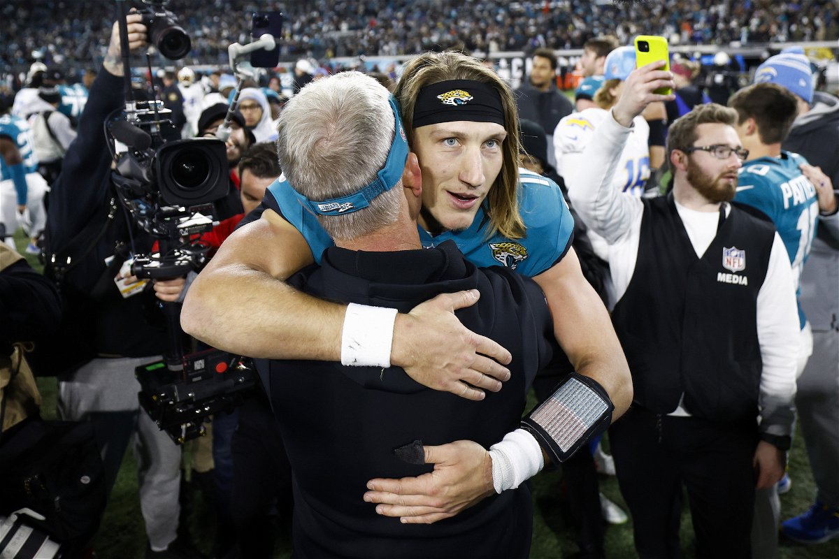 <i>Douglas P. DeFelice/Getty Images</i><br/>Trevor Lawrence celebrates on the field after the Jaguars defeated the Los Angeles Chargers 31-30 in the AFC Wild Card playoff game at TIAA Bank Field on January 14 in Jacksonville