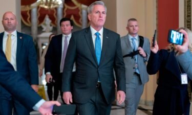 Speaker of the House Kevin McCarthy talks to reporters as he walks to his office at the Capitol in Washington