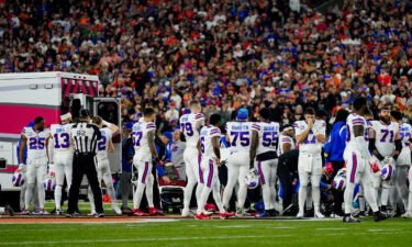 The Buffalo Bills gather as an ambulance parks on the field while CPR is administered to Bills safety Damar Hamlin in Cincinnati on January 2.