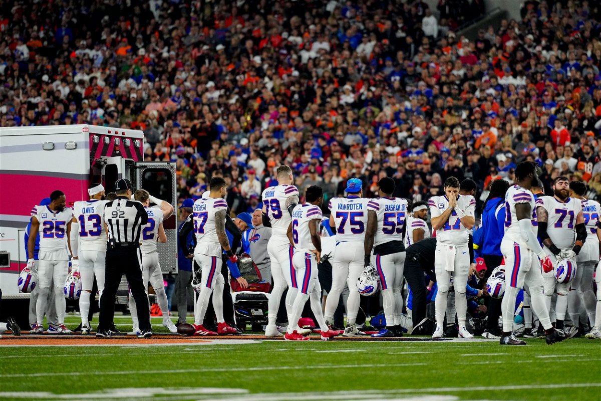 <i>Sam Greene/USA Today Sports/Reuters</i><br/>The Buffalo Bills gather as an ambulance parks on the field while CPR is administered to Bills safety Damar Hamlin in Cincinnati on January 2.