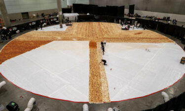 Cooks work inside the Los Angels Convention center as Pizza Hut attempts to create the World's largest pizza of 14