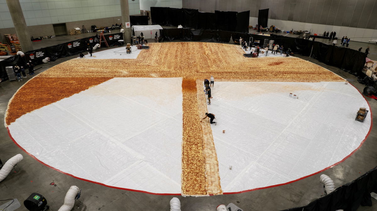 <i>Mike Blake/Reuters</i><br/>Cooks work inside the Los Angels Convention center as Pizza Hut attempts to create the World's largest pizza of 14