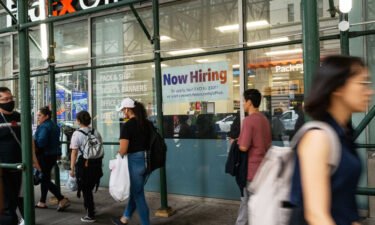 A "now hiring" sign is displayed in a window in Manhattan on July 28