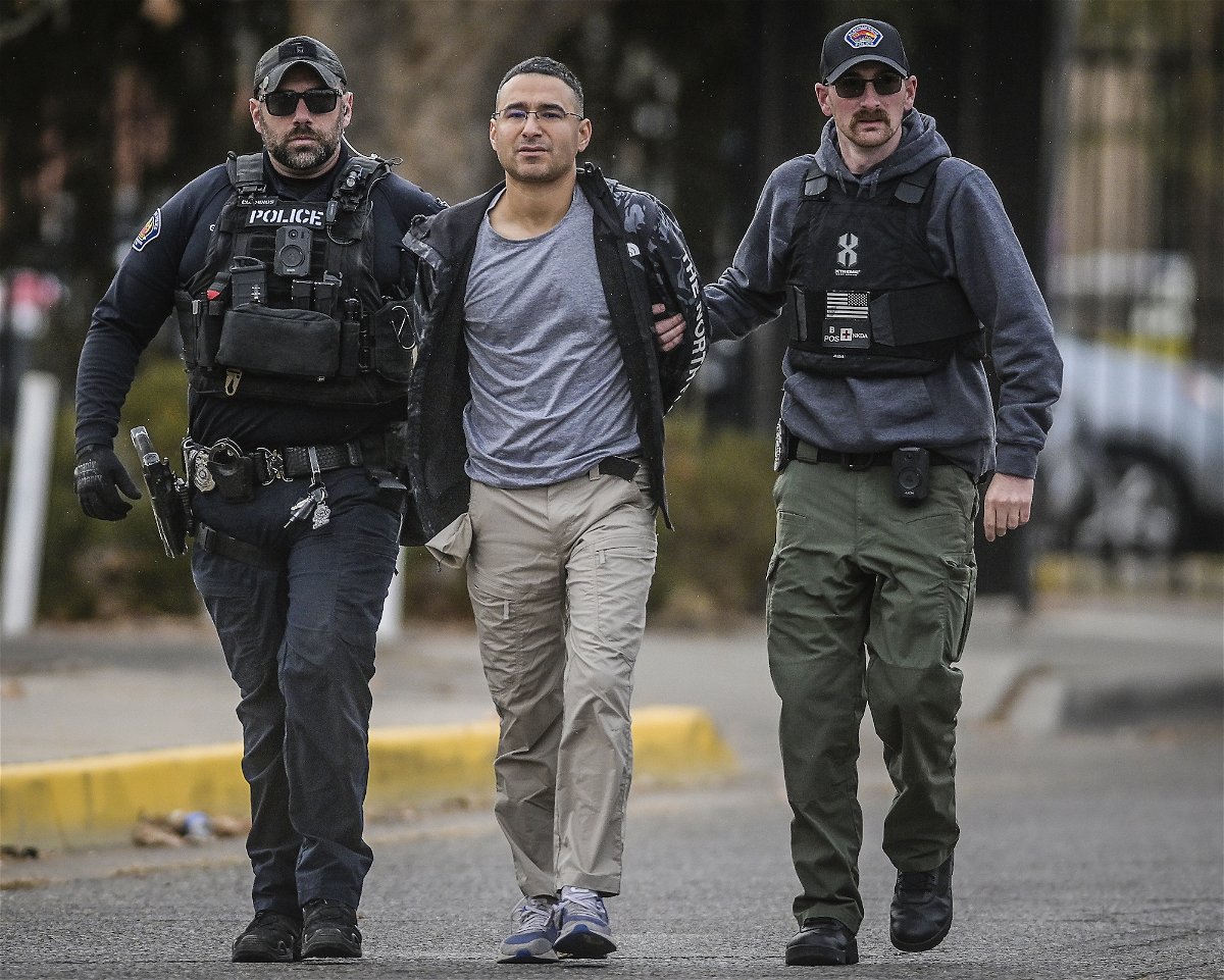 <i>Roberto E. Rosales/The Albuquerque Journal/AP</i><br/>A grand jury indicted Solomon Peña (center) on 14 counts of shooting and firearms charges.