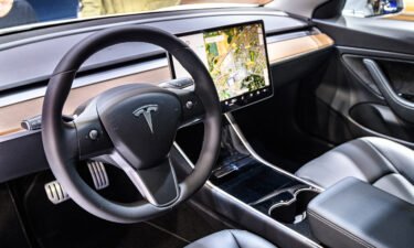 Tesla Model 3 compact full electric car interior with a large touch screen on the dashboard on display at Brussels Expo on January 9